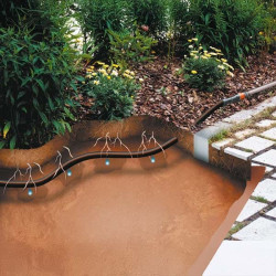 Schéma en coupe d’un tuyau micro-drip Gardena enterré montrant un arrosage direct au niveau des racines, efficace pour les massi